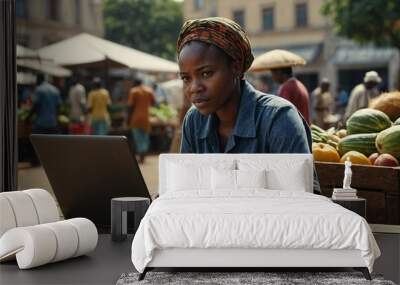 African Farmer Using Laptop Computer on a City Square with Vendors Selling Fresh Organic Agricultural Products, Middle Aged Black Female Managing Business Operations and Communications with Suppliers Wall mural