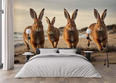 four hares, rabbits running through a on the beach Wall mural