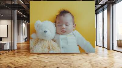 A cute little baby, against a solid lemon yellow background, enjoys a cozy nap with a fluffy stuffed animal, radiating warmth and cuteness. Wall mural