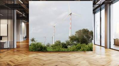 Sustainable Energy: Wind Turbines Towering Above Green Landscape Wall mural