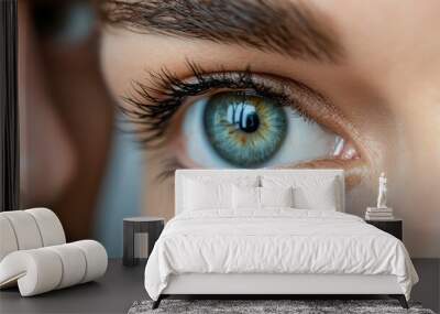 A beautifully clear blue eye captured in sharp focus, revealing detailed patterns of the iris and reflection of light, showcasing the intricacies of human vision with precision. Wall mural