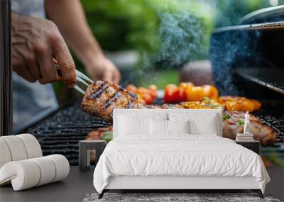 A person grills meat and vegetables on a barbecue, captured at the height of a summer cookout with sizzling meats, vibrant veggies, and smoky goodness filling the air. Wall mural