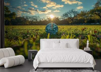 A picturesque view of a glass globe with a sunflare in the backdrop highlights the beauty of nature and our planet's splendor Wall mural