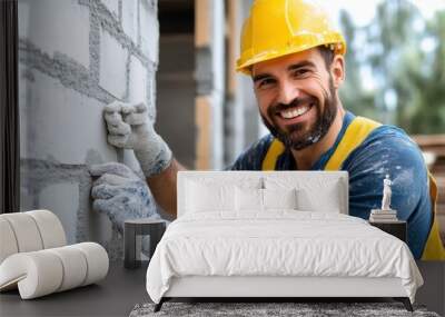 A smiling construction worker wearing a yellow helmet and safety gear plastering a brick wall exterior, showcasing his skills and dedication in building and construction. Wall mural