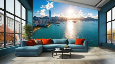 A stunning sunny aerial view captures a city skyline with skyscrapers and a bustling harbor filled with boats, framed by a blue sky with scattered clouds. Wall mural