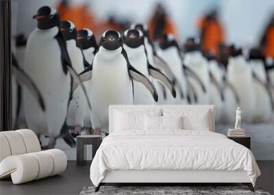 An engaging image of a large group of penguins walking in a line on the snowy ground, displaying a sense of coordination and the harsh yet beautiful polar environment. Wall mural