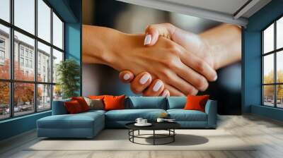 This image captures a close-up view of two people shaking hands, symbolizing agreement, trust, partnership, and mutual respect in a professional setting. Wall mural