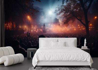 Under the twinkling stars and illuminated by the warm glow of tree-lined lanterns, a sea of eager fans sway to the pulsating beat of their favorite band, lost in the magic of a captivating outdoor co Wall mural