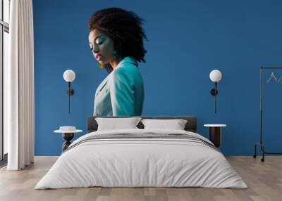  attractive african american woman in suit isolated on blue Wall mural