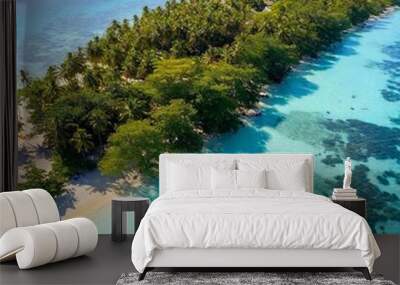 A full shot birds-eye-view photo of a serene island scenery, featuring a small island with a forested center and a sandy shoreline, with soft focus on the calm waters around it. Wall mural