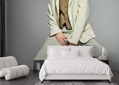 A young man with red hair showcases an elegant smart casual outfit in a minimalist grey backdrop. Wall mural