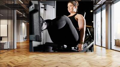 A young woman confidently exercises in her active wear, embracing body positivity while working out. Wall mural