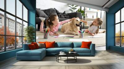 adorable kids petting golden retriever dog while drawing pictures on floor at home Wall mural