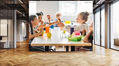 adorable schoolgirls taking lunch at school cafeteria Wall mural