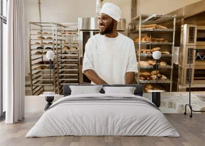 african american baker preparing raw dough for pastry on baking manufacture Wall mural