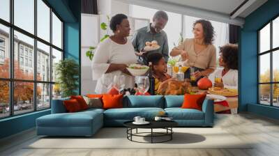 African american grandparents holding food near family and thanksgiving dinner Wall mural