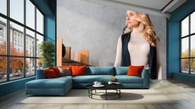 attractive and blonde businesswoman in turtleneck looking away in office Wall mural