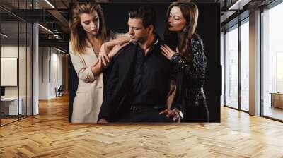 attractive and stylish women handsome man isolated on black Wall mural