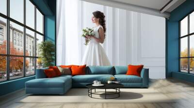 attractive happy bride posing in traditional dress with wedding bouquet Wall mural