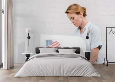 attractive woman voting near stand with vote lettering and american flag Wall mural