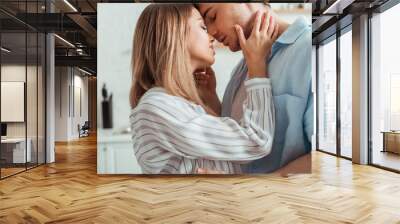 attractive woman with closed eyes touching boyfriend Wall mural