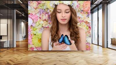 attractive young woman in floral wreath holding blue butterfly Wall mural