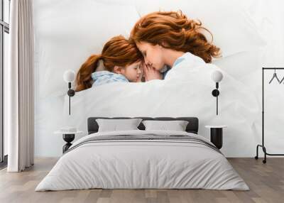 beautiful redhead mother and daughter sleeping together in bed Wall mural