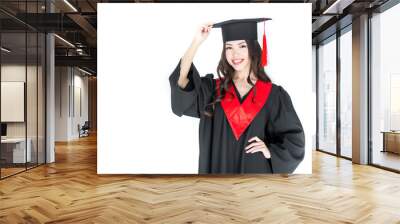 Beautiful young brunette woman adjusting mortarboard and smiling at camera Wall mural