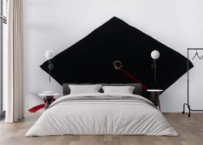 Black graduation cap with red tassel and diploma on white background Wall mural