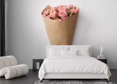 bouquet of beautiful pink roses wrapped in craft paper on grey Wall mural