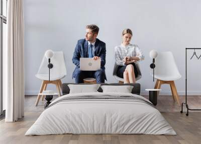 Business people with laptop and wristwatch waiting job interview in office Wall mural