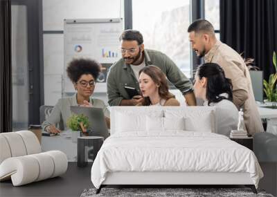 candid photo, interracial business team discussing project and sharing ideas in modern coworking Wall mural