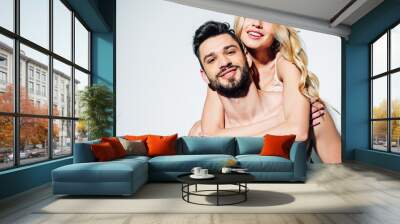 cheerful blonde young woman hugging happy bearded man on white Wall mural