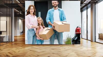 cheerful kid and happy bearded man holding boxes Wall mural