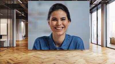 cheerful young and brunette woman looking at camera Wall mural