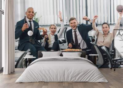 cheerful young business people drinking beer and eating pizza in office Wall mural