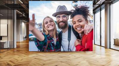 cheerful young multiethnic friends smiling at camera in amusement park Wall mural