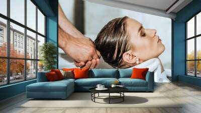 close-up partial view of hairdresser washing hair to attractive young woman in beauty salon Wall mural