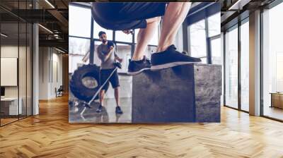 Close-up partial view of sporty people exercising at cross fit gym workout Wall mural