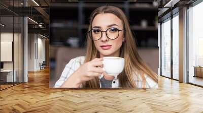 close-up portrait of beautiful young woman drinking coffee Wall mural