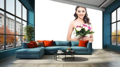 close-up portrait of young bride in wedding dress with earrings and tiara holding bouquet isolated on white Wall mural