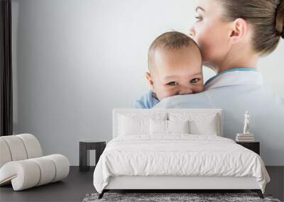 close-up shot of female pediatrician with african american baby isolated on white Wall mural