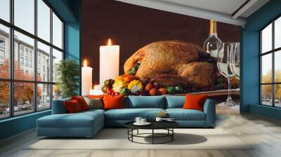 close up view of candles, traditional roasted turkey, vegetables and glasses of wine for thanksgiving dinner on wooden tabletop Wall mural