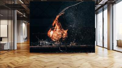 close-up view of delicious juicy meat with ribs and meat fork preparing on grill Wall mural