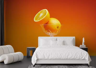 close-up view of fresh ripe oranges in glass on orange background Wall mural