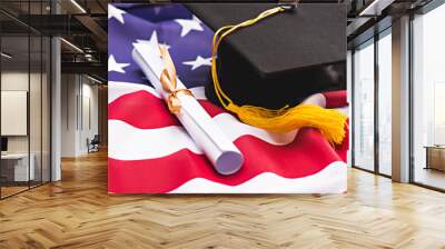 Close-up view of graduation mortarboard and diploma on US flag, education concept Wall mural