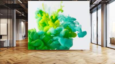 close up view of mixing of green, yellow and bright turquoise paints splashes in water isolated on gray Wall mural