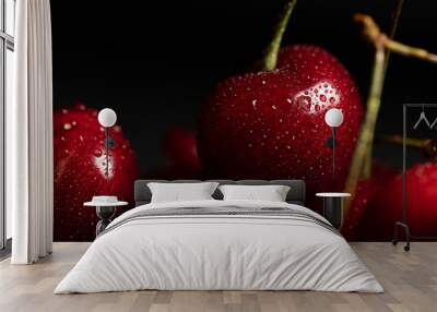 close up view of red delicious shiny cherries with water drops isolated on black Wall mural