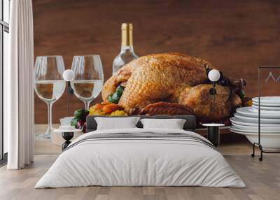 close up view of traditional roasted turkey, vegetables and glasses of wine for thanksgiving dinner Wall mural