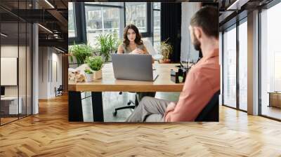 Colleagues share thoughts amidst a challenging layoff conversation. Wall mural